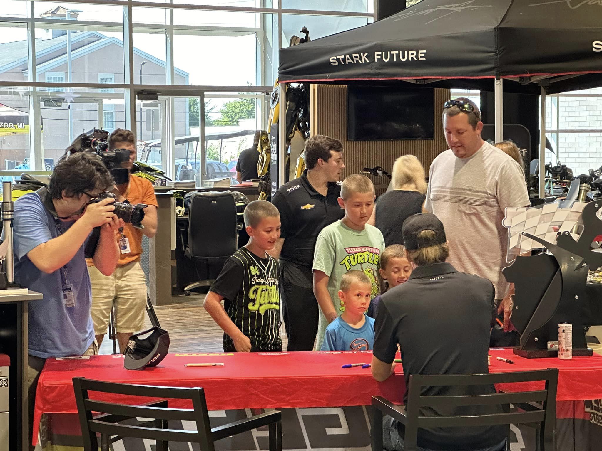 Fans gathered around Carson Hocevar during the Zeigler Meet & Greet at Zeigler Motorsports