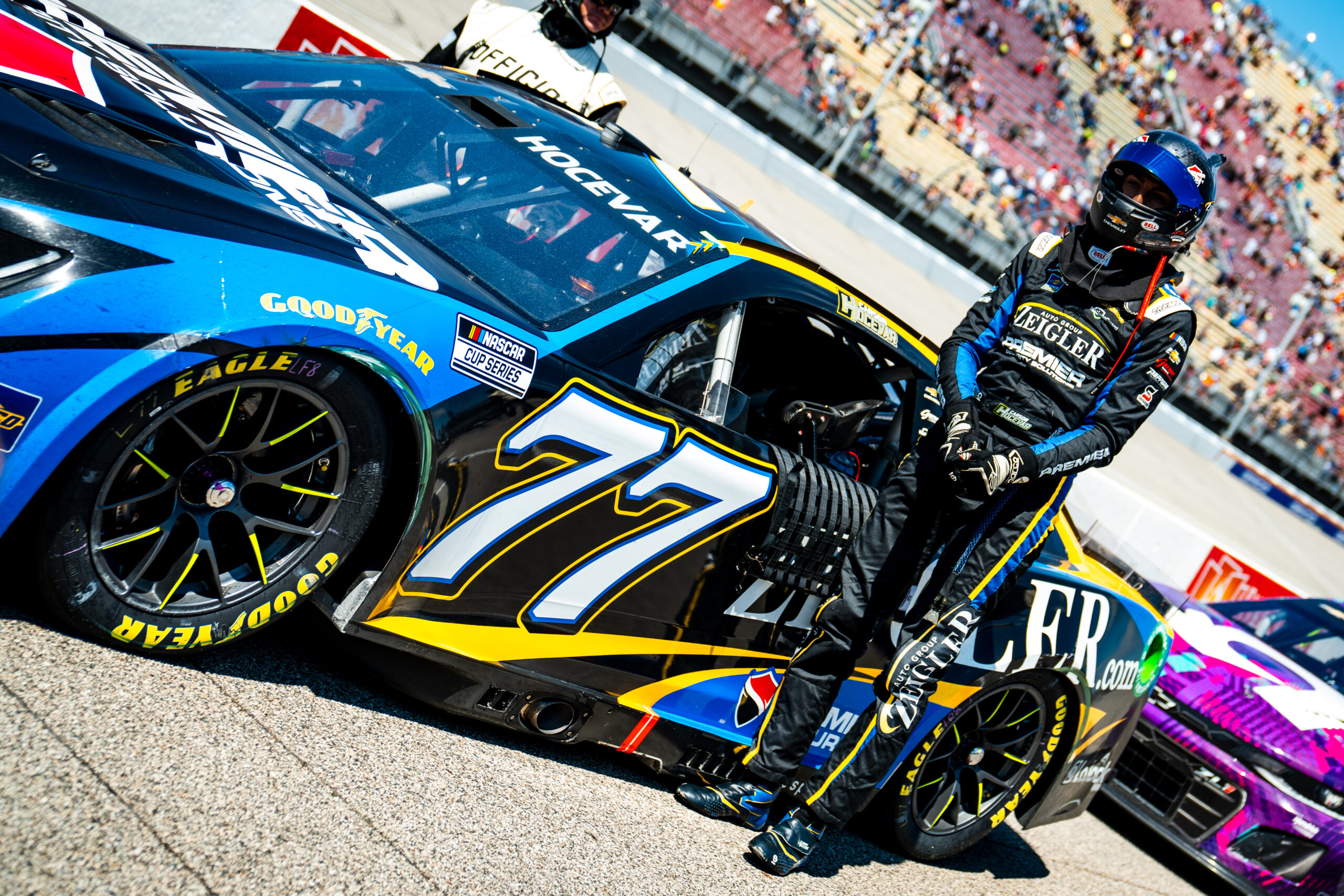 Carson Hocevar poses with the Zeiglerdotcom 77 Camaro at the 2024 Firekeepers Casino at Michigan International Speedway